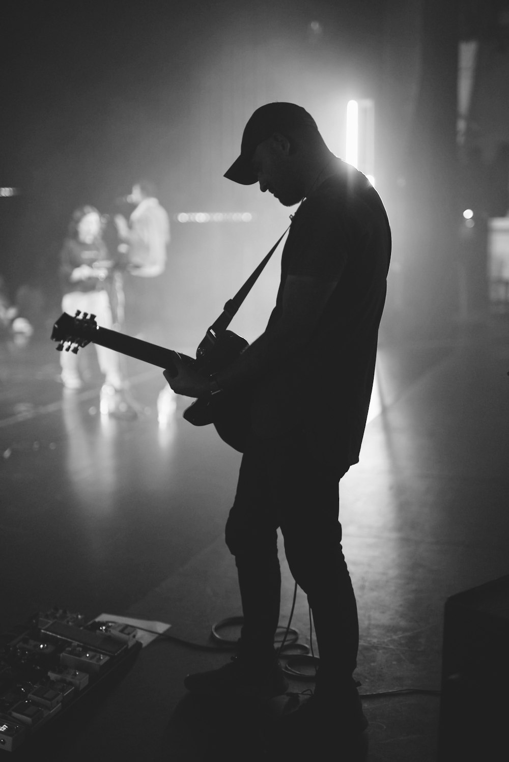 man playing guitar on stage