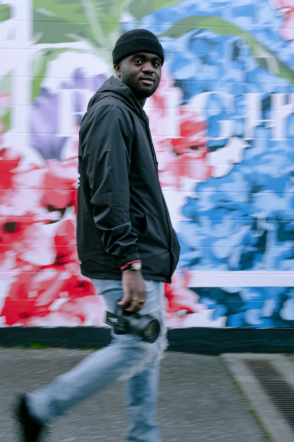 man in black jacket walking on street