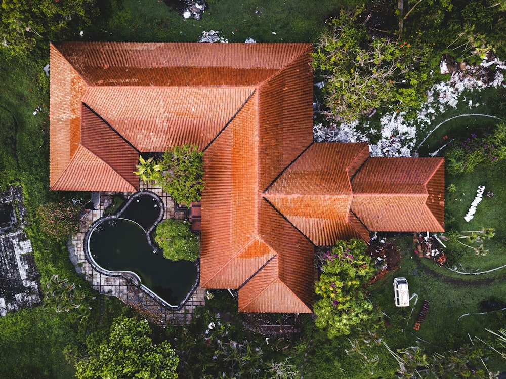 brown brick building surrounded by green trees