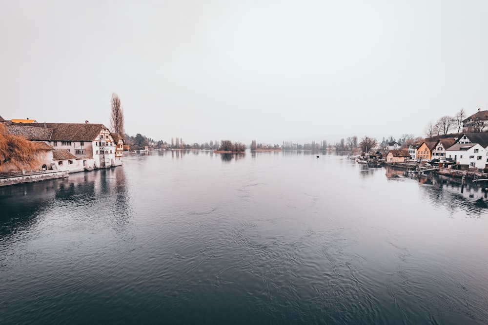 body of water near city buildings during daytime