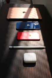 Close-up of sleek electronic gadgets arranged neatly with soft lighting.