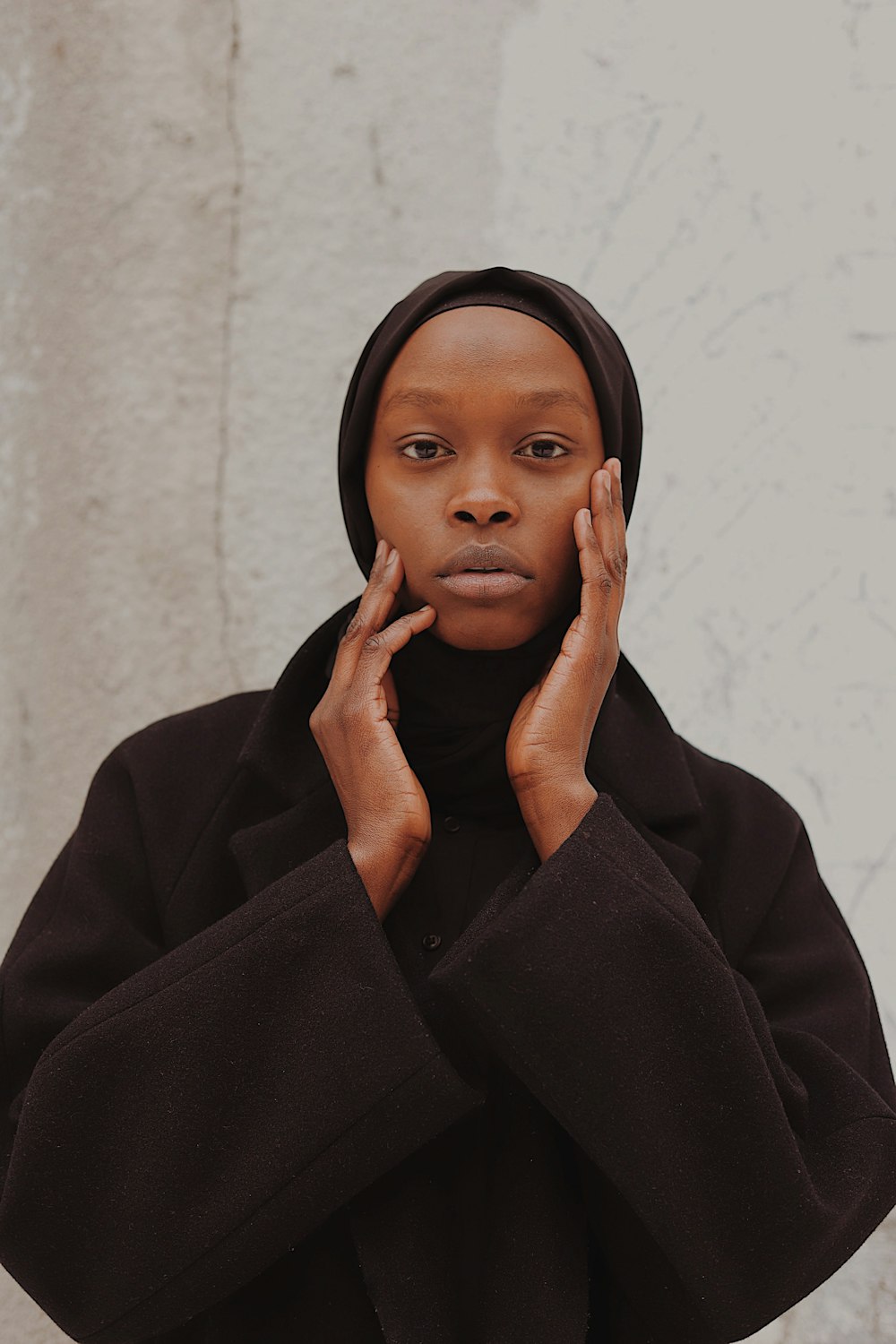 woman in black coat and black hijab