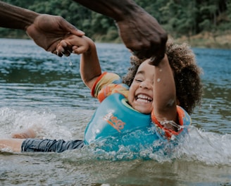 woman in orange and blue life vest on water