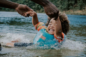 woman in orange and blue life vest on water