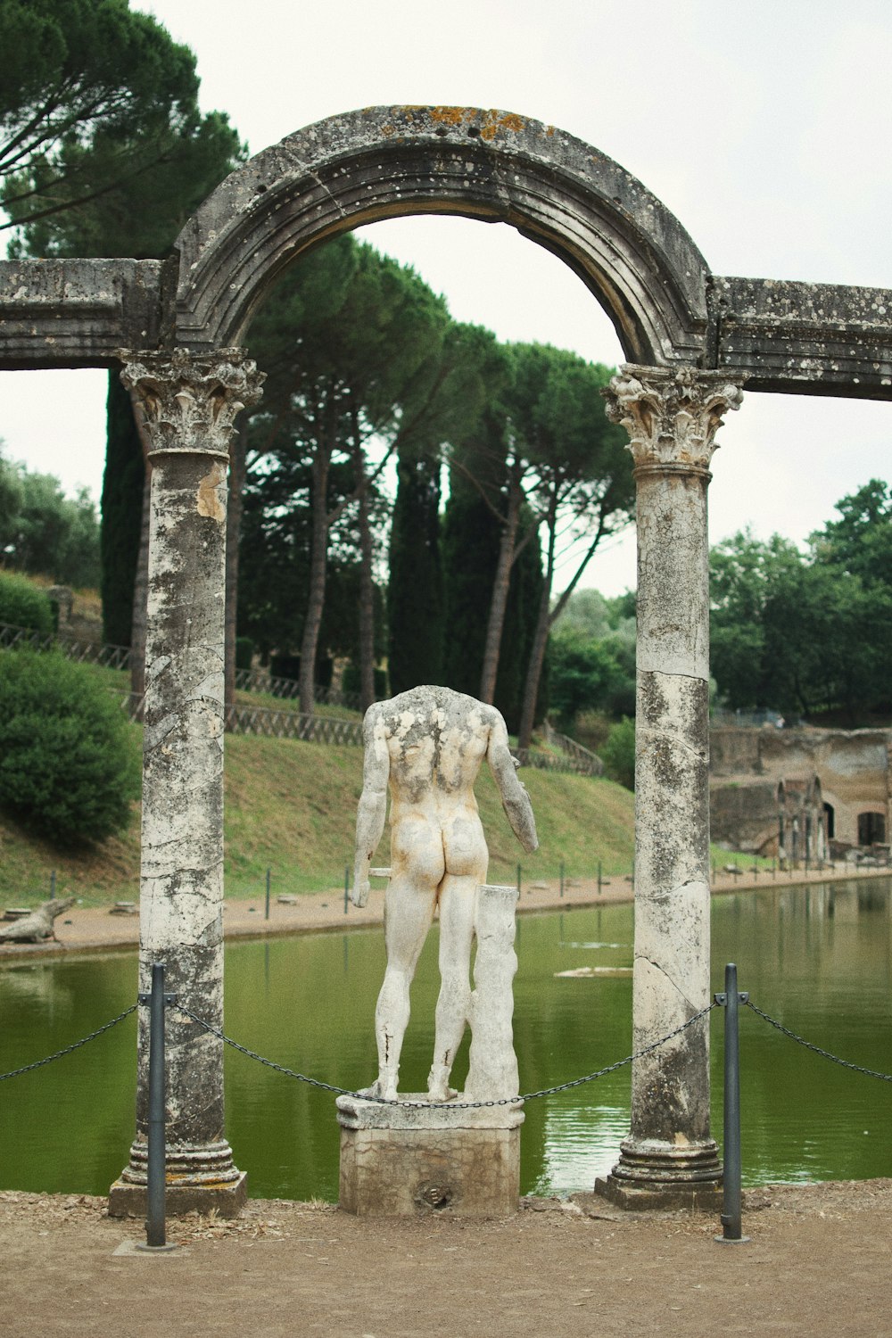 white horse statue near body of water during daytime