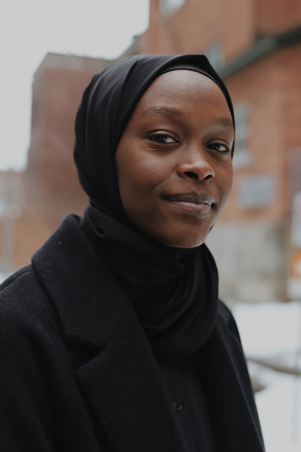 woman in black hijab and black coat