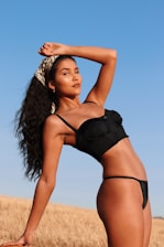 A glamorous Indian bikini model posing confidently on a sunlit beach, blending fitness and fashion.