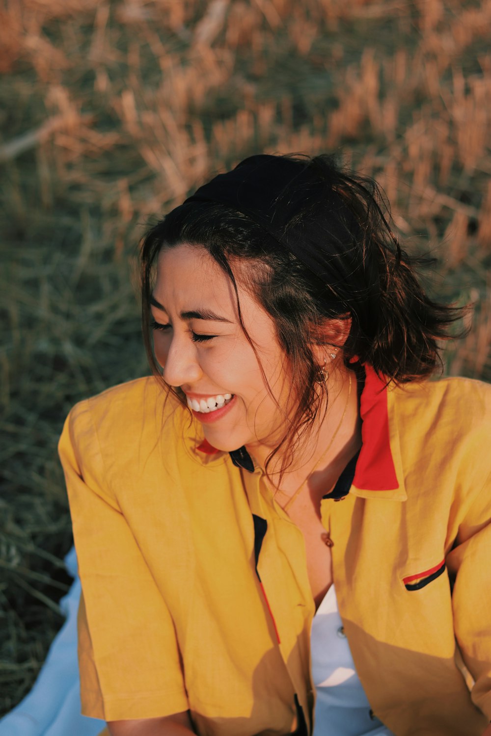 woman in yellow button up shirt smiling
