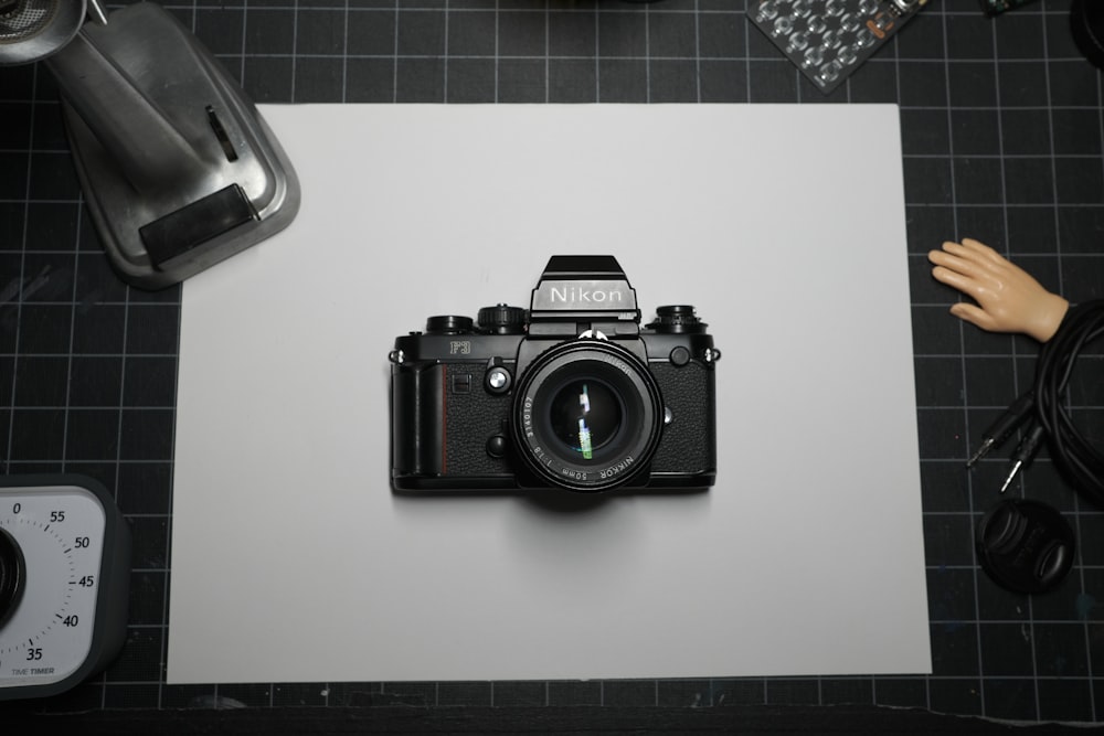 black nikon dslr camera on white table