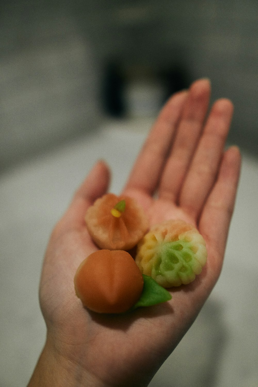 person holding orange round fruit