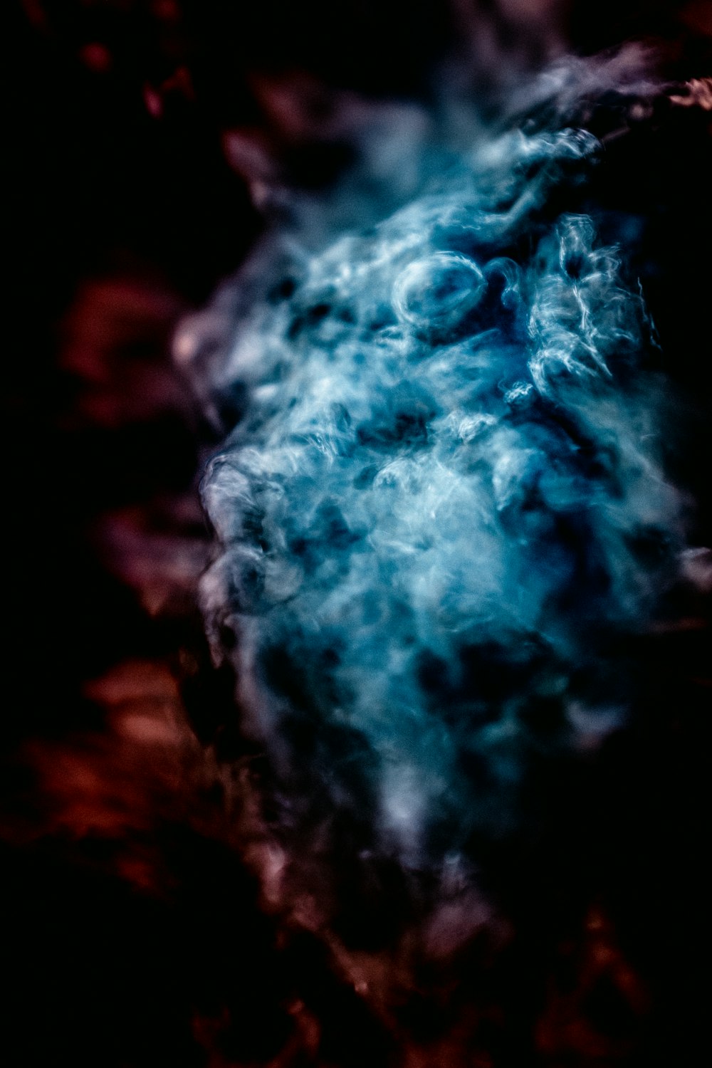 white and blue smoke in close up photography