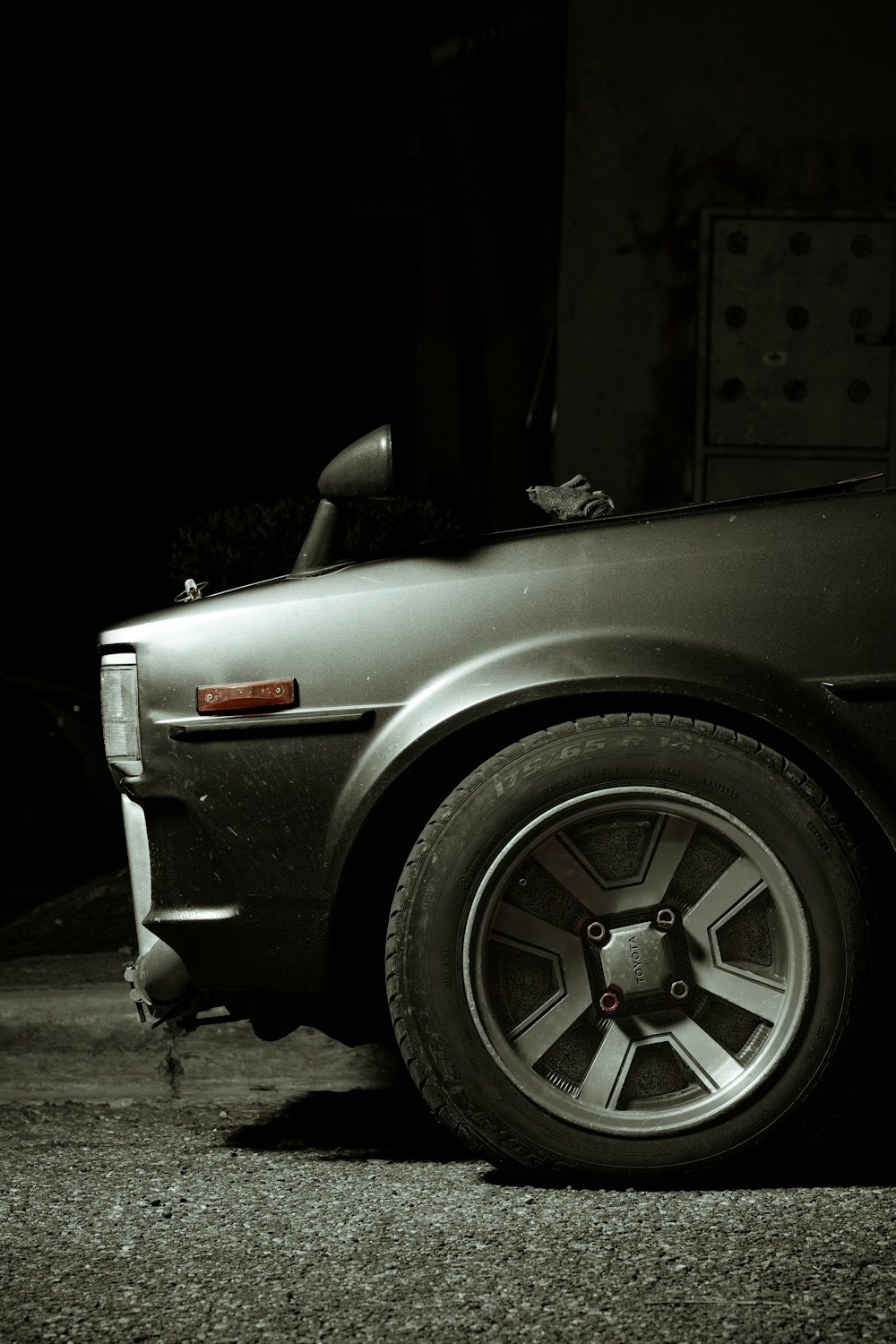 grayscale photo of car with wheel