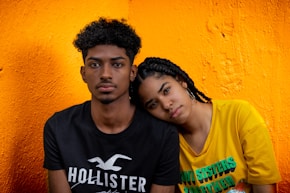 man in black crew neck shirt beside woman in yellow crew neck t-shirt