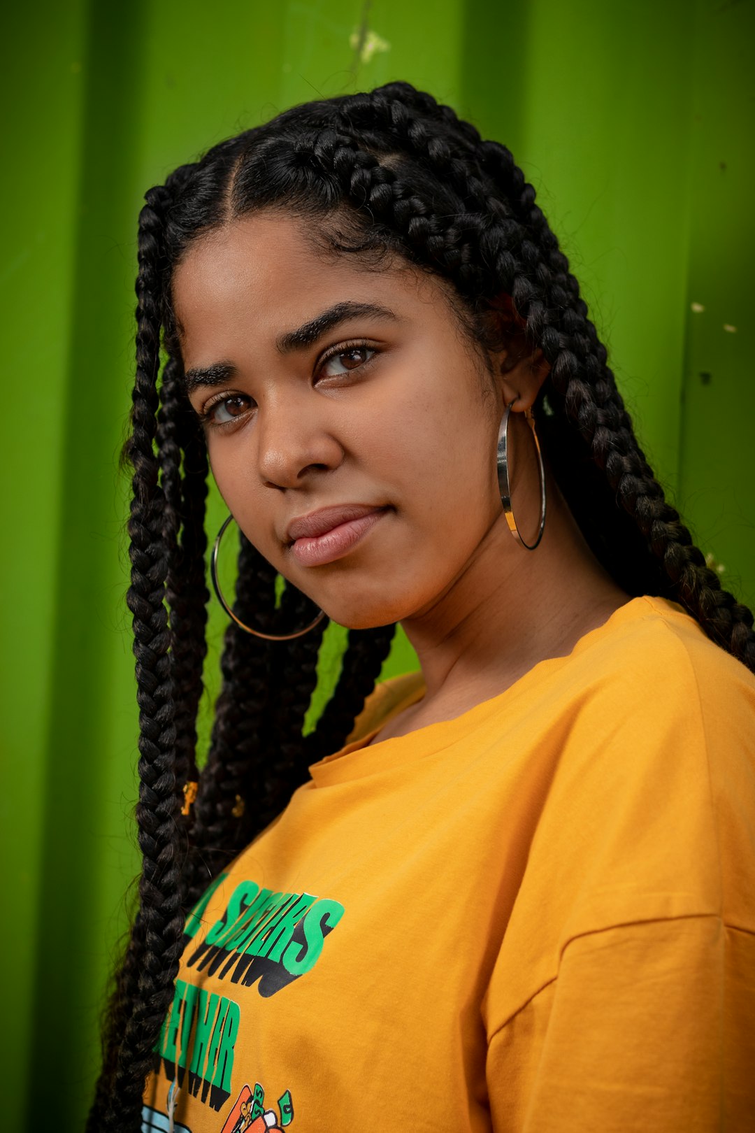 woman in yellow crew neck shirt wearing black braided hair