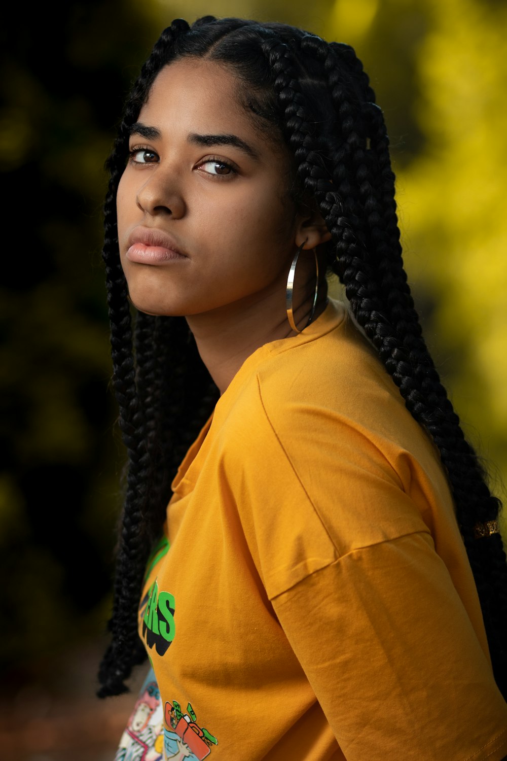 woman in yellow hoodie wearing black knit cap