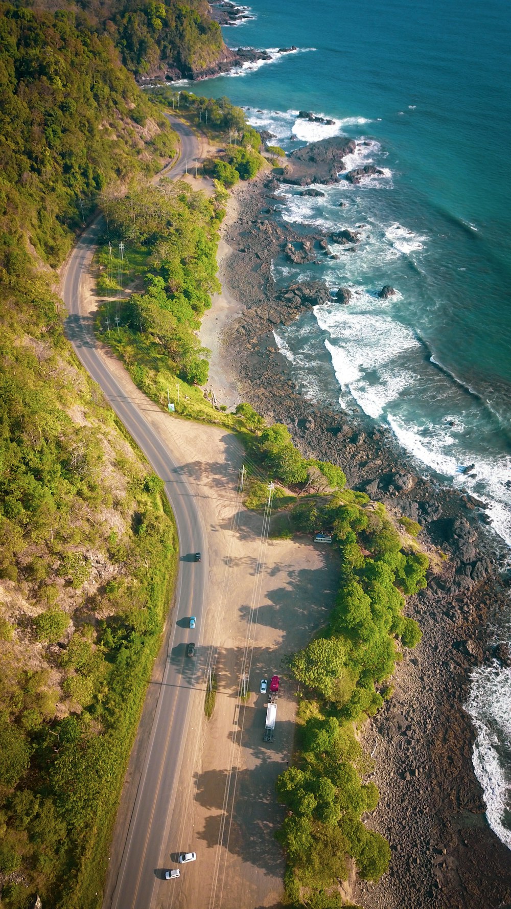 aerial view of road near body of water during daytime