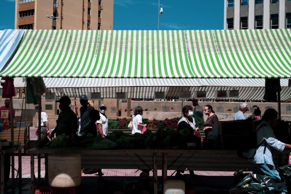 people sitting on brown wooden bench during daytime