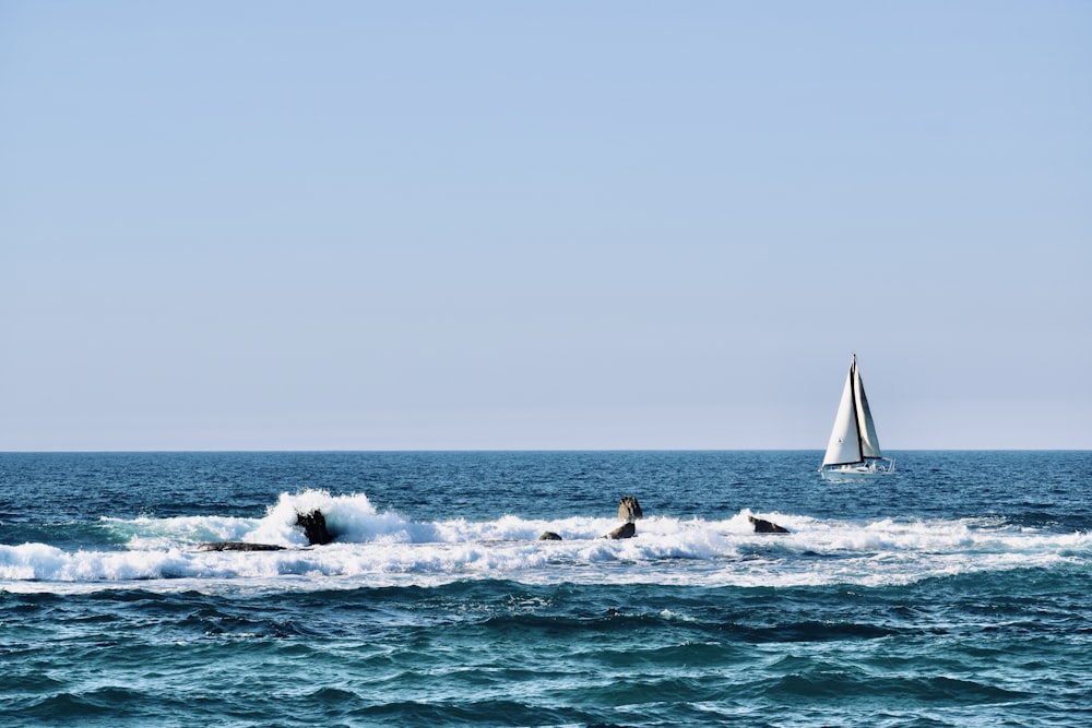 white sailboat on sea during daytime