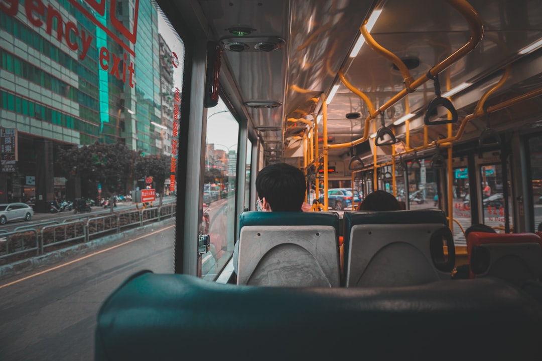 people sitting on bus seat during daytime