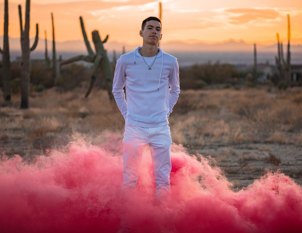 man in gray long sleeve shirt and pink pants standing on pink powder