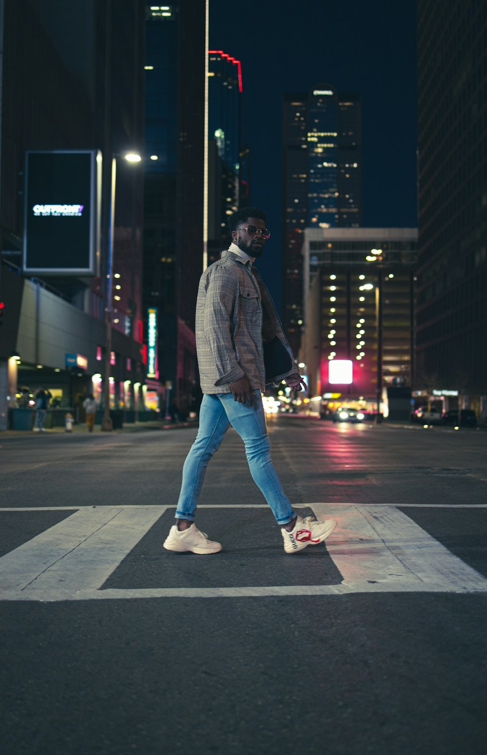 medeleerling Geestig extase man in gray jacket and blue denim jeans standing on sidewalk during night  time photo – Free Clothing Image on Unsplash