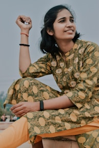 A person smiling while wearing the copper magnetic bracelet during a peaceful outdoor walk.