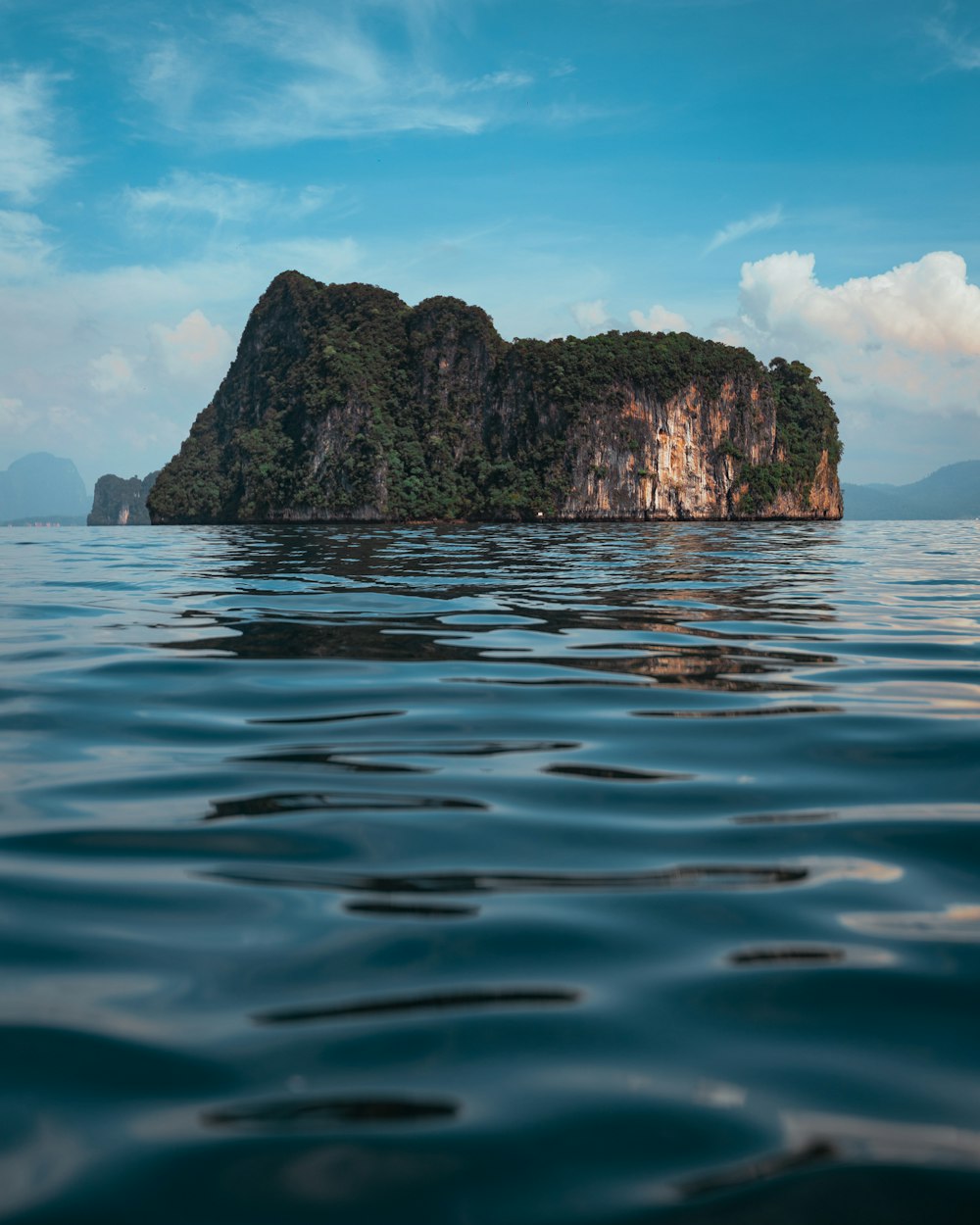 brown rock formation on blue sea water during daytime