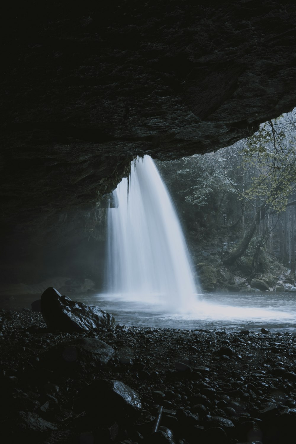 water falls in cave during daytime