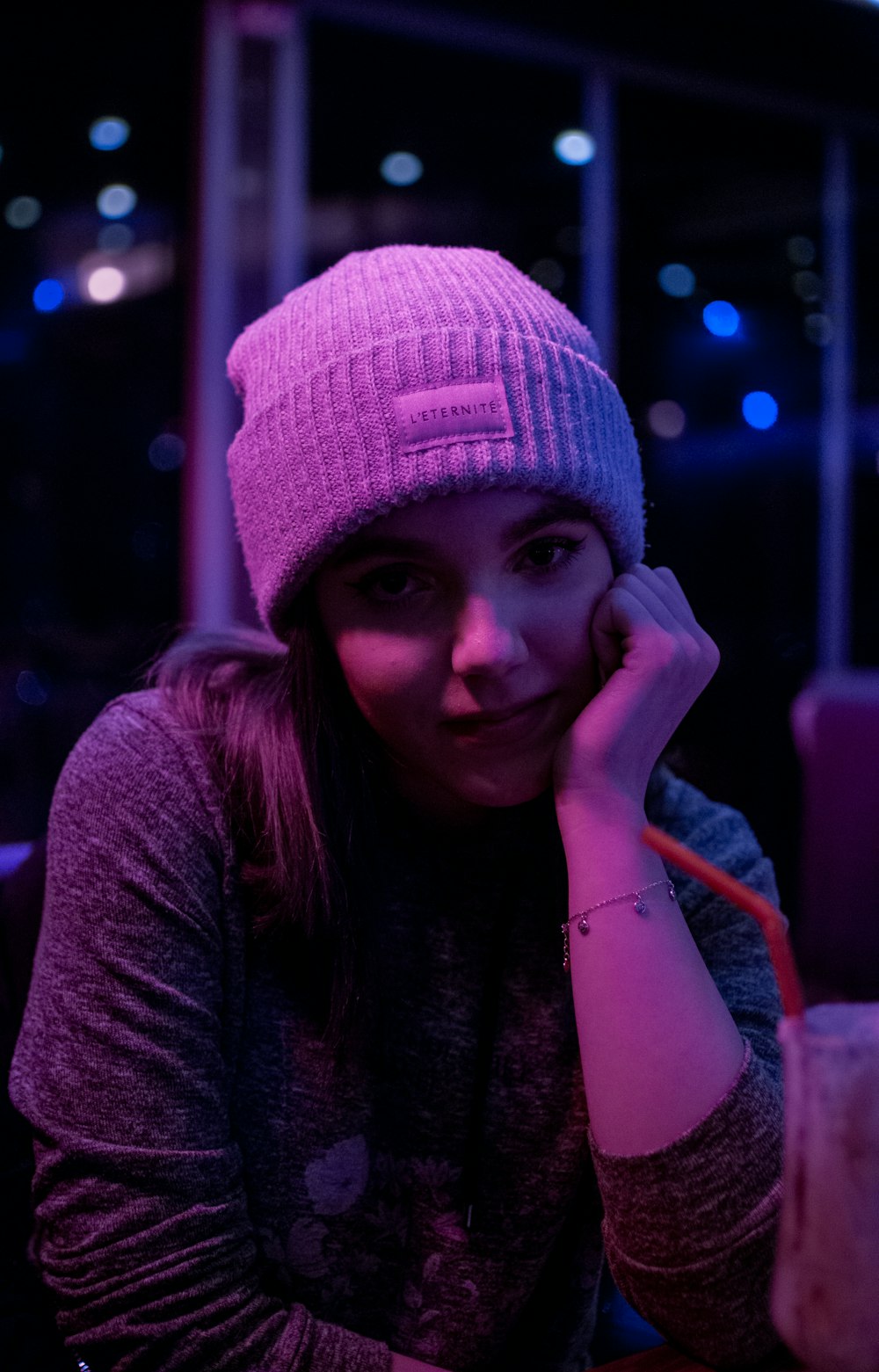 woman in pink knit cap and maroon long sleeve shirt