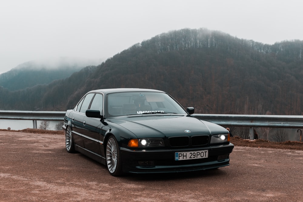 black audi a 4 coupe on brown dirt road during daytime