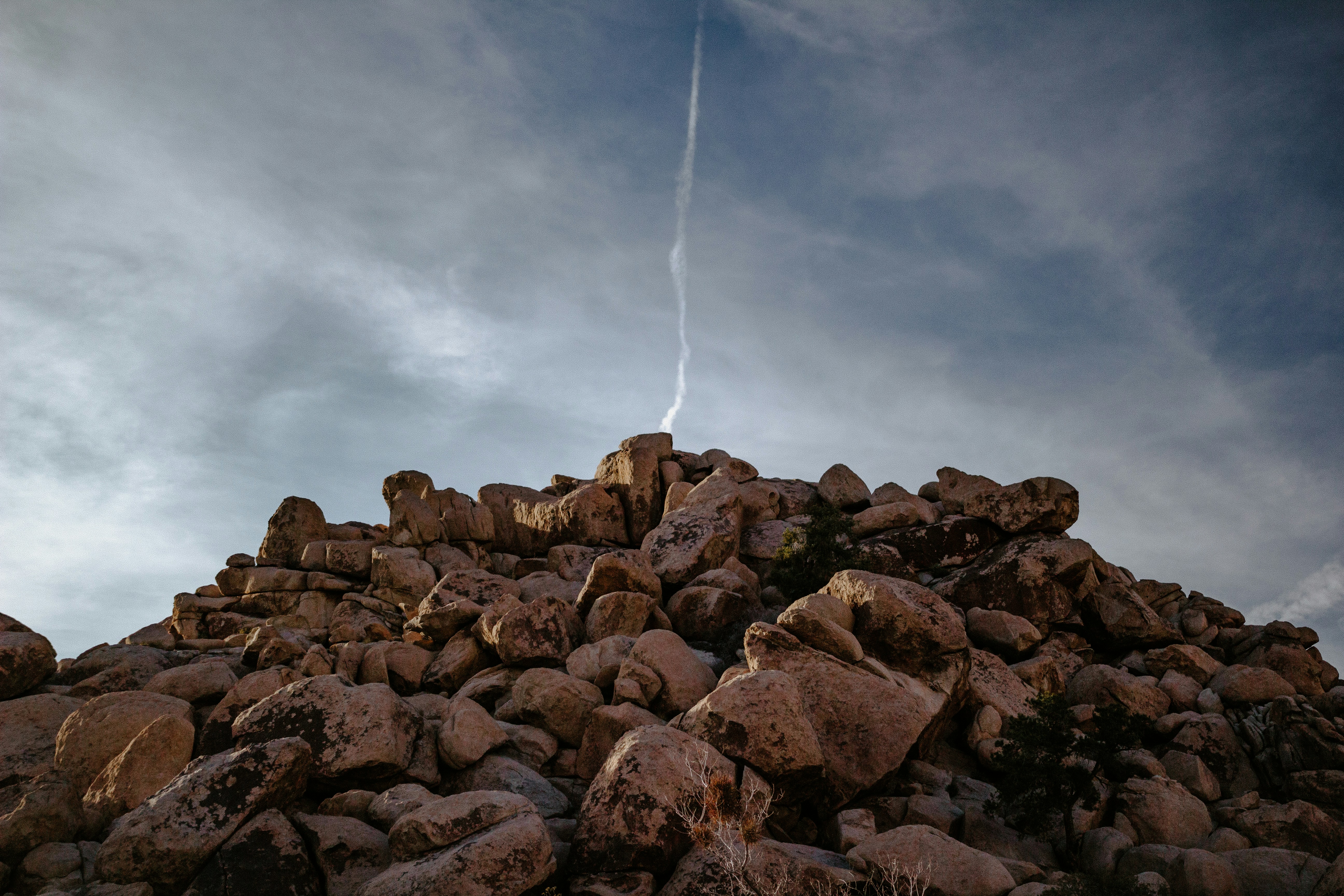 brown rocks under white clouds during daytime
