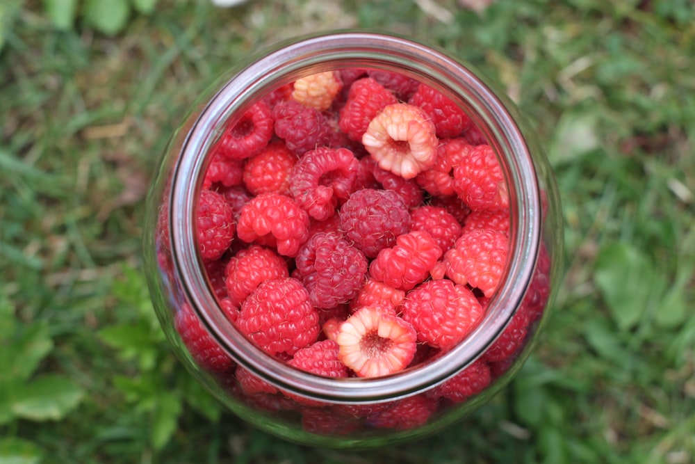 red strawberries in clear glass jar