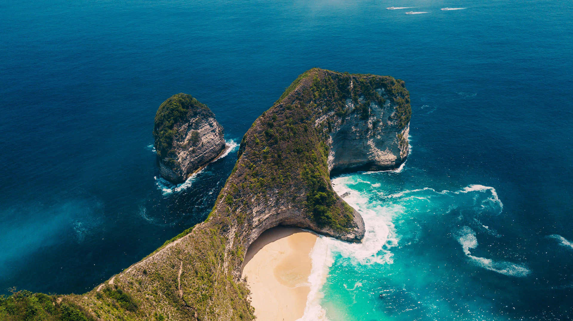 brown and green rock formation on blue sea water during daytime