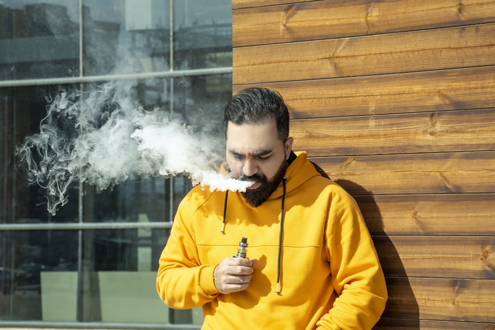 man in yellow jacket smoking