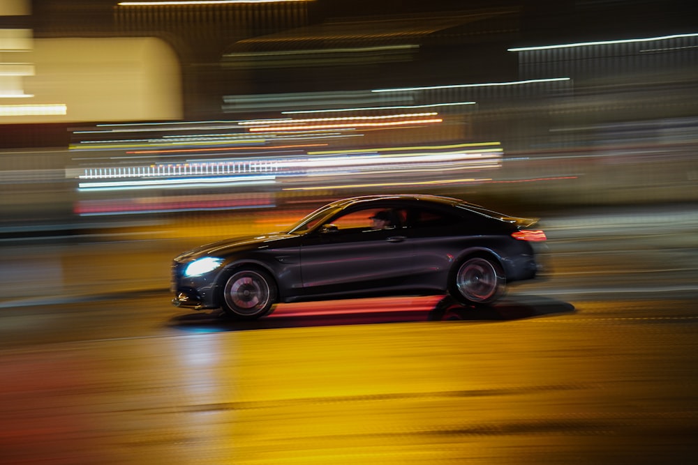 black sedan on road during night time