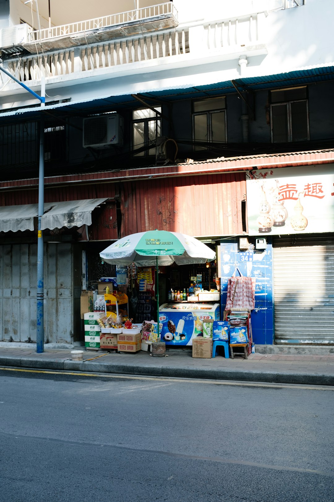 blue and white food stall beside store during daytime