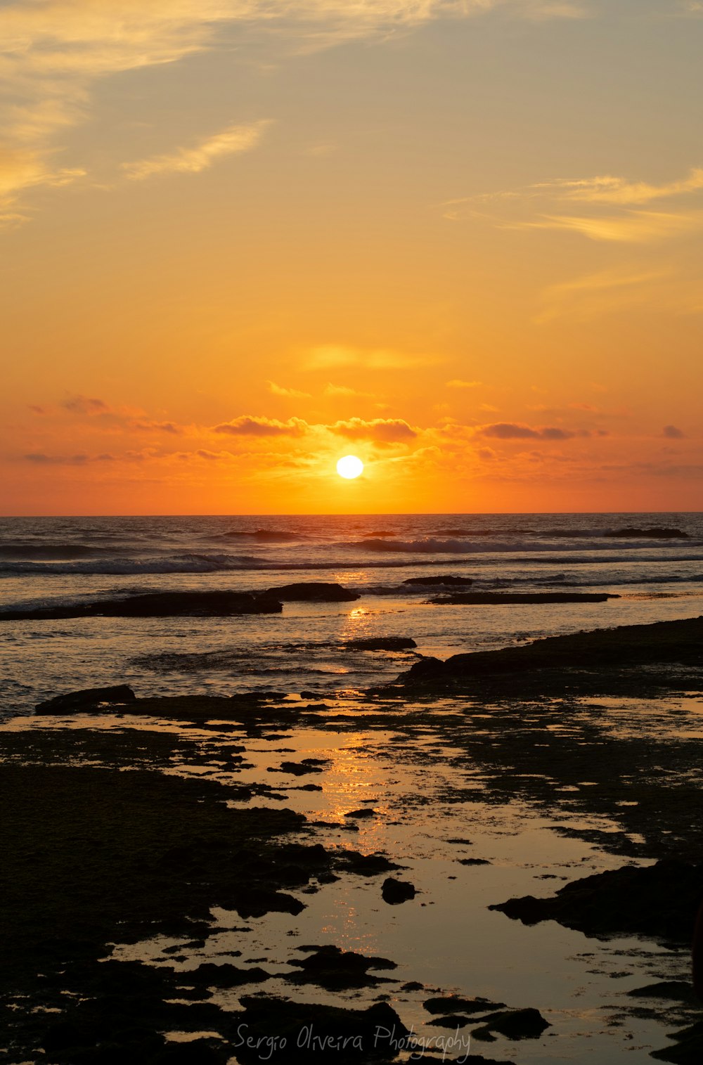 body of water during sunset