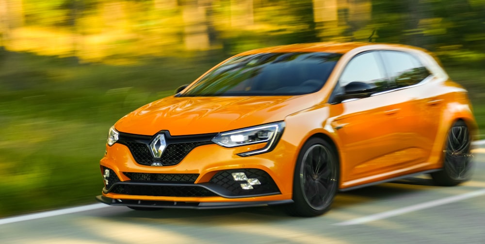 orange honda car on road during daytime