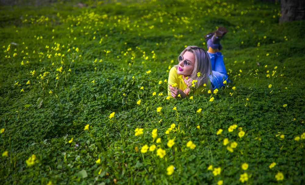 girl in yellow jacket on yellow flower field during daytime