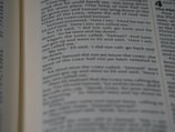 A close-up view of a page from a book with text clearly visible, discussing a narrative involving characters Samuel and Eli.