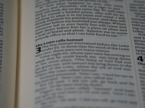 An open book displaying text in a serif font on light-colored pages. The visible text includes a heading and several lines of body text, with certain words emphasized in bold.
