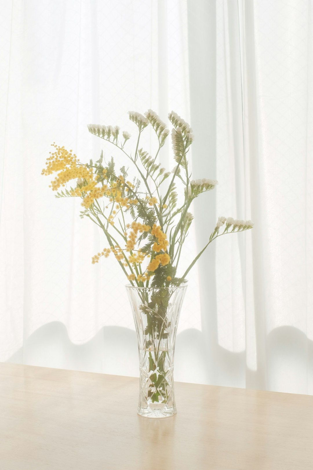 white and green flower in clear glass vase