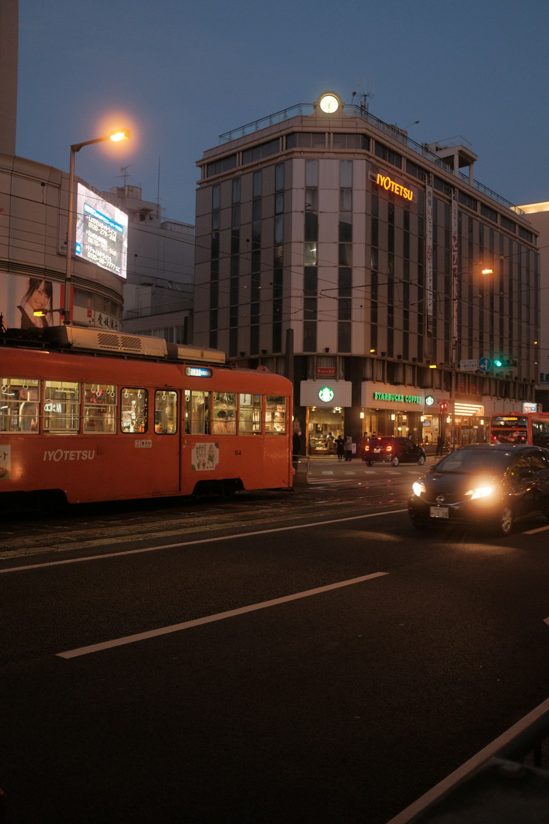 red and yellow tram on road near brown concrete building during daytime