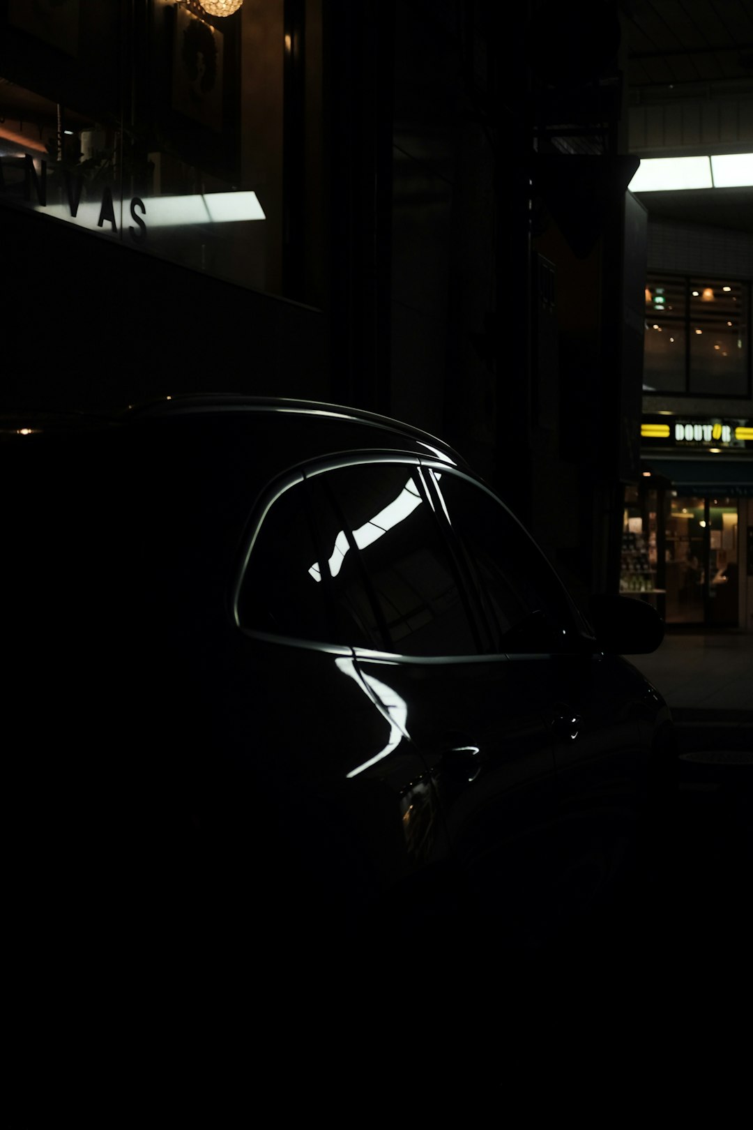 black car parked near building during night time