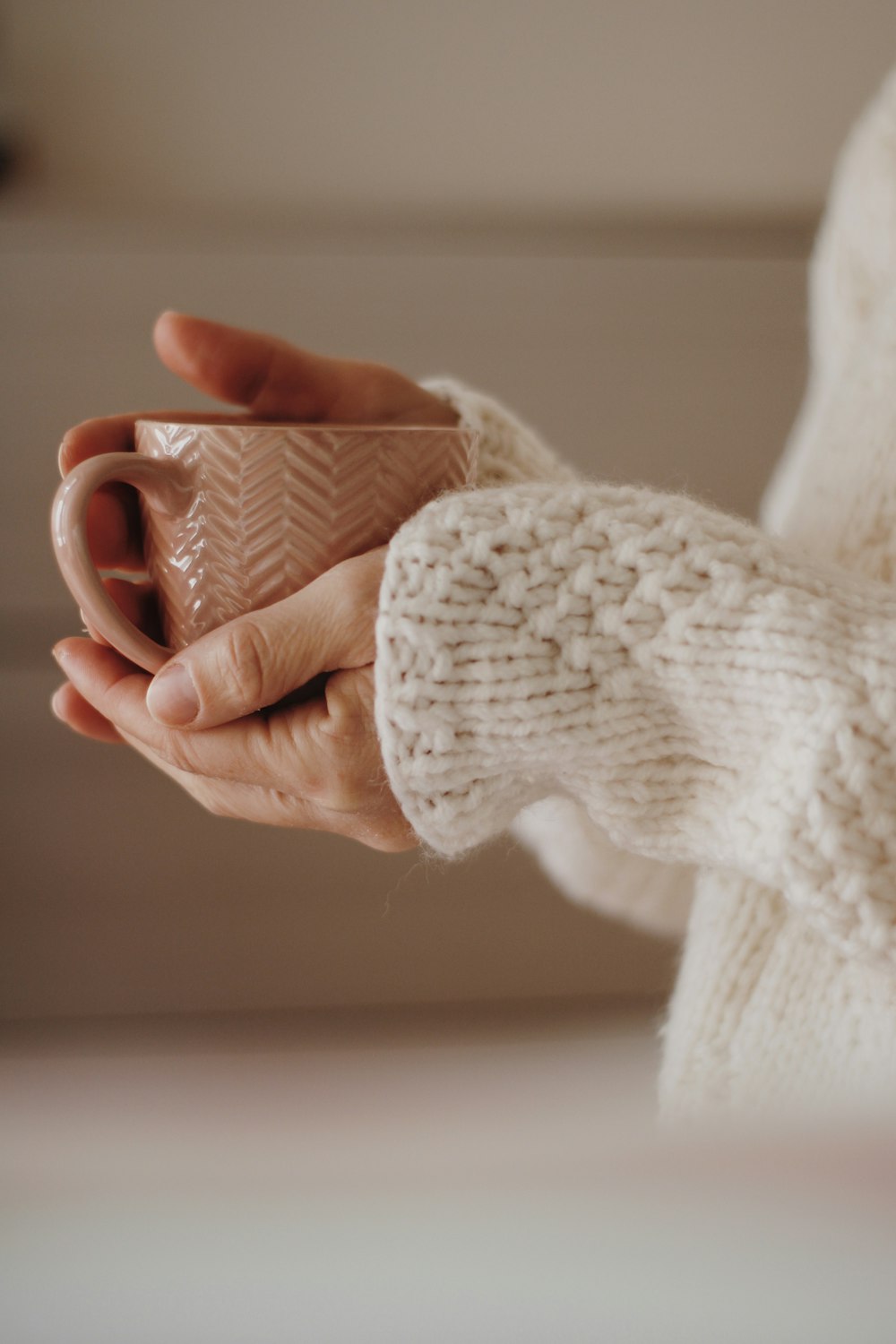 person holding white ceramic mug