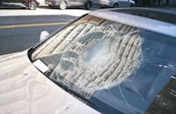 A cracked windshield before repair, highlighting the damage we expertly fix.