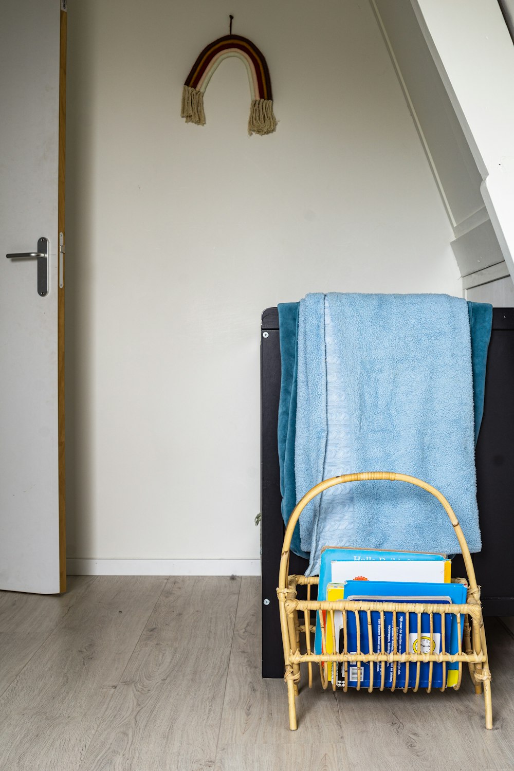 blue towel on brown wooden chair