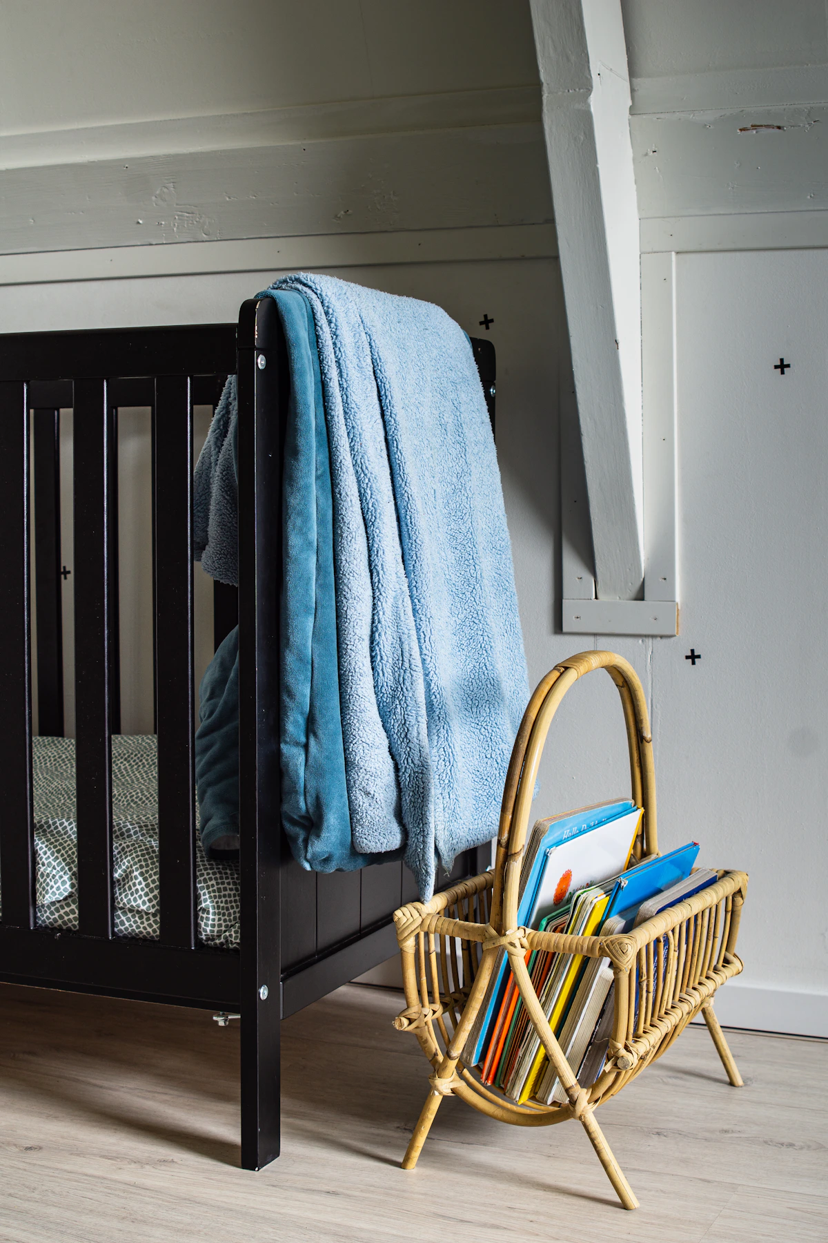 Bath towel arranged beside a baby crib