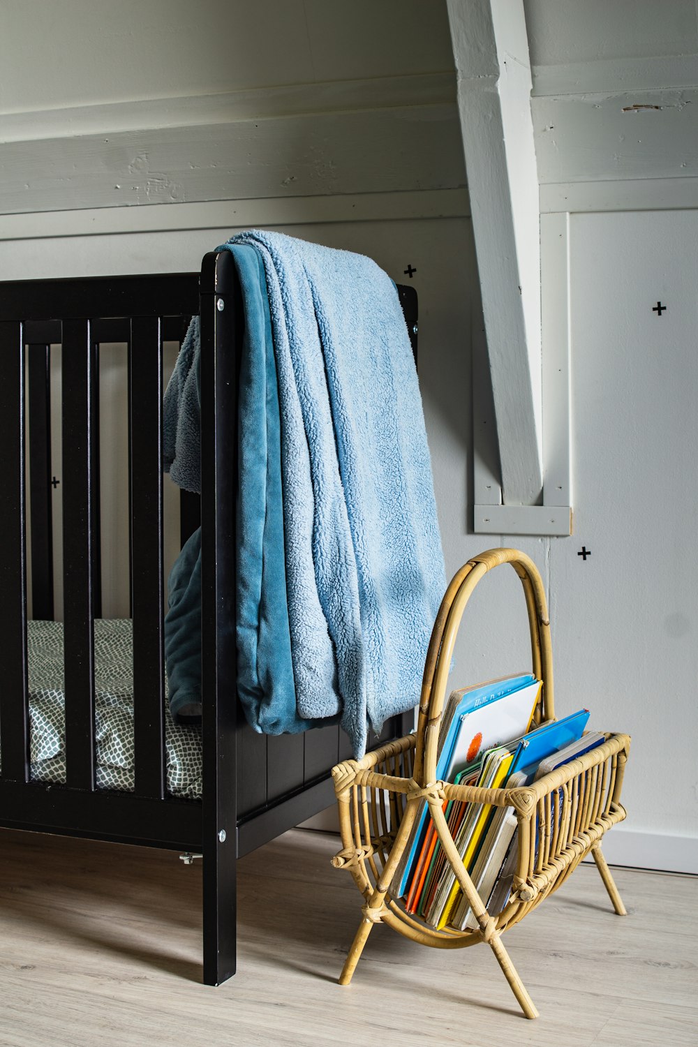 blue bath towel on white wooden crib