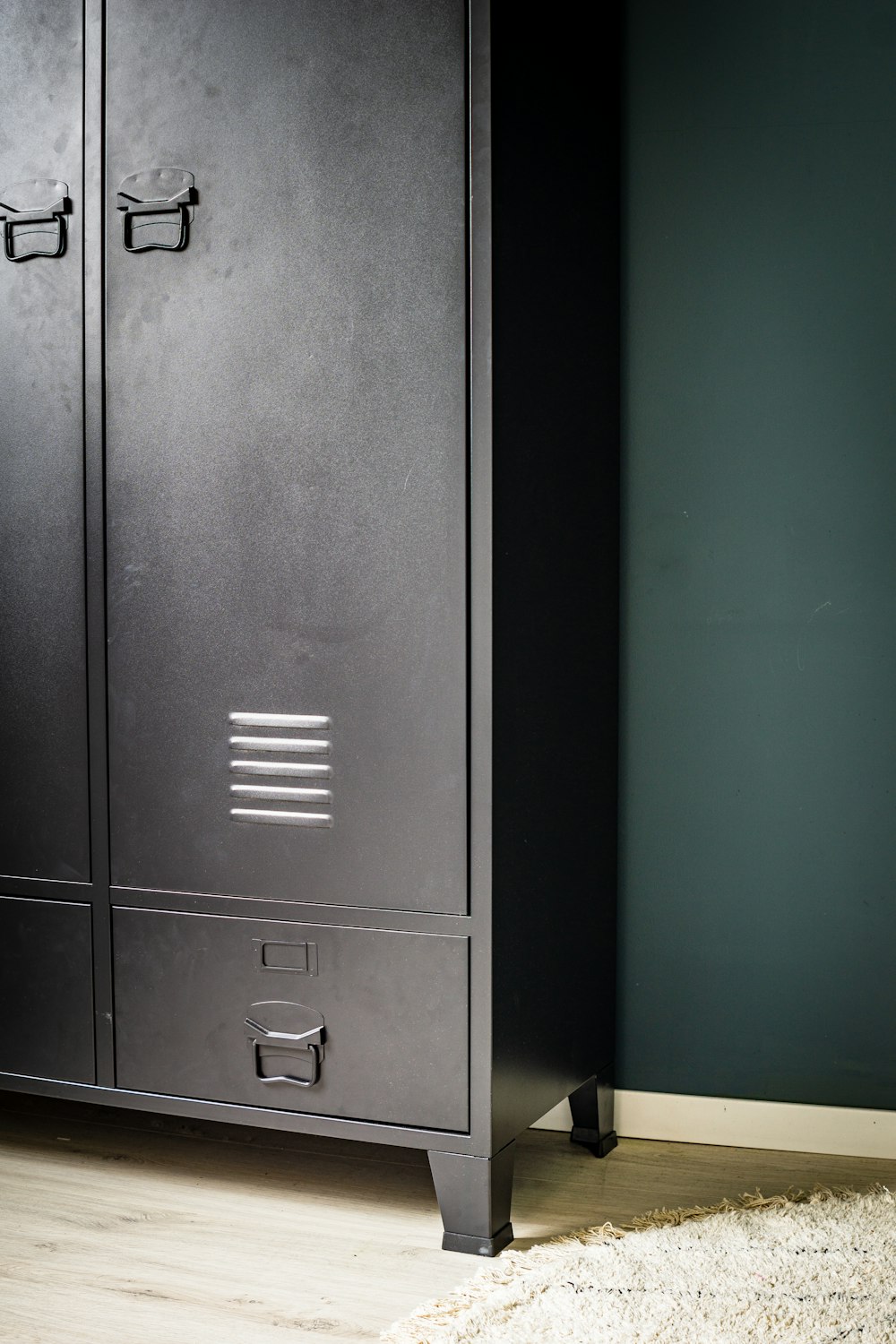black wooden cabinet beside white wall